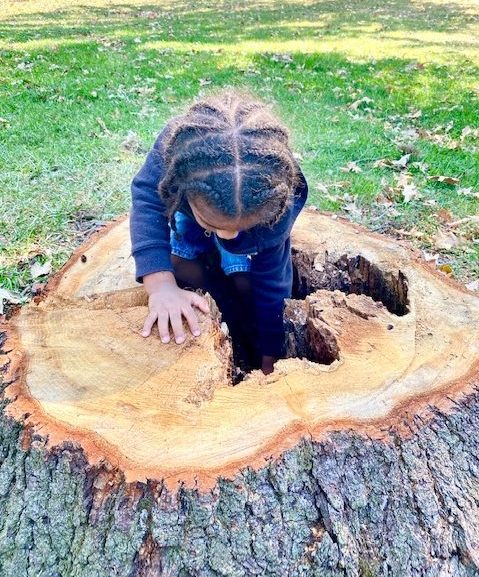 A Total Child student exploring outdoors